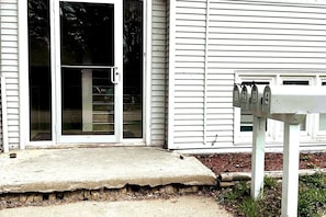 A house with a concrete front porch, a sliding glass door, and a mailbox with four slots. - Economy 3 beds Great Location! (Moorhead)