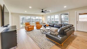 A spacious living room with a large sofa, two armchairs, a coffee table, and a ceiling fan. - Grand Lakefront Home in Hot Springs w/ Boat Dock! (Hot Springs)
