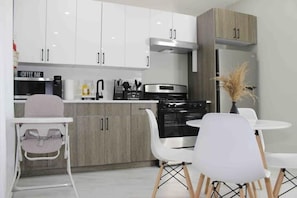 Fridge, microwave, cookware/dishes/utensils, dining tables