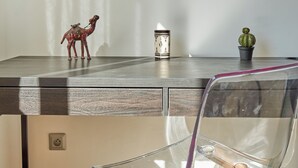 A modern room with a desk, a chair, a small cactus, and a decorative horse figurine. - Stayhere Rabat - Hassan Heritage (Rabat)
