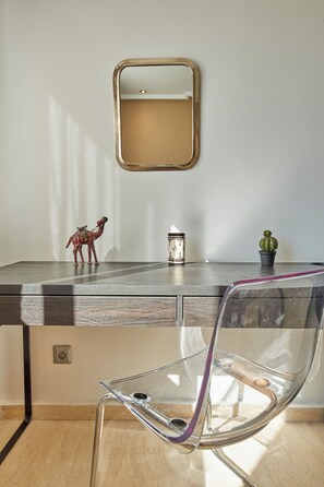 A modern room with a desk, a chair, a small cactus, and a decorative horse figurine. - Stayhere Rabat - Hassan Heritage (Rabat)