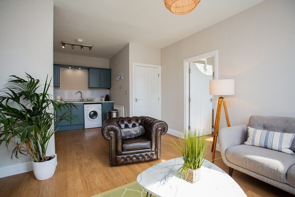 Experience the epitome of coastal chic in your beautifully appointed living area. Soft natural light floods the space, highlighting the elegant decor and thoughtful design touches.