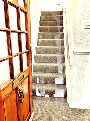 A wooden door with a brass handle and a window with multiple panes. - Inviting 2-bed House in Birmingham (Birmingham)