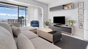 Een moderne woonkamer met een bank, televisie en planten.