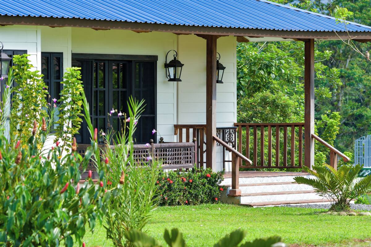 A house with a porch, a staircase, and a garden.