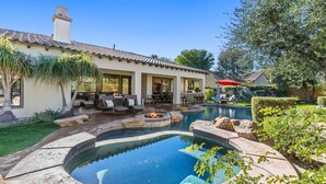 A house with a swimming pool, outdoor seating, and a fire pit. - Serenity Retreat at Montage, by GPM - Pool + Gameroom + More! Walk to Festivals (Indio)