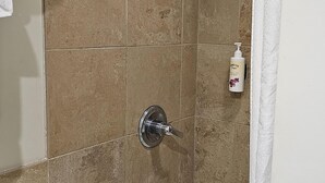 A bathroom with a bathtub, a shower, and a toilet. - Cute Studio in Palms at Waikiki (Honolulu)