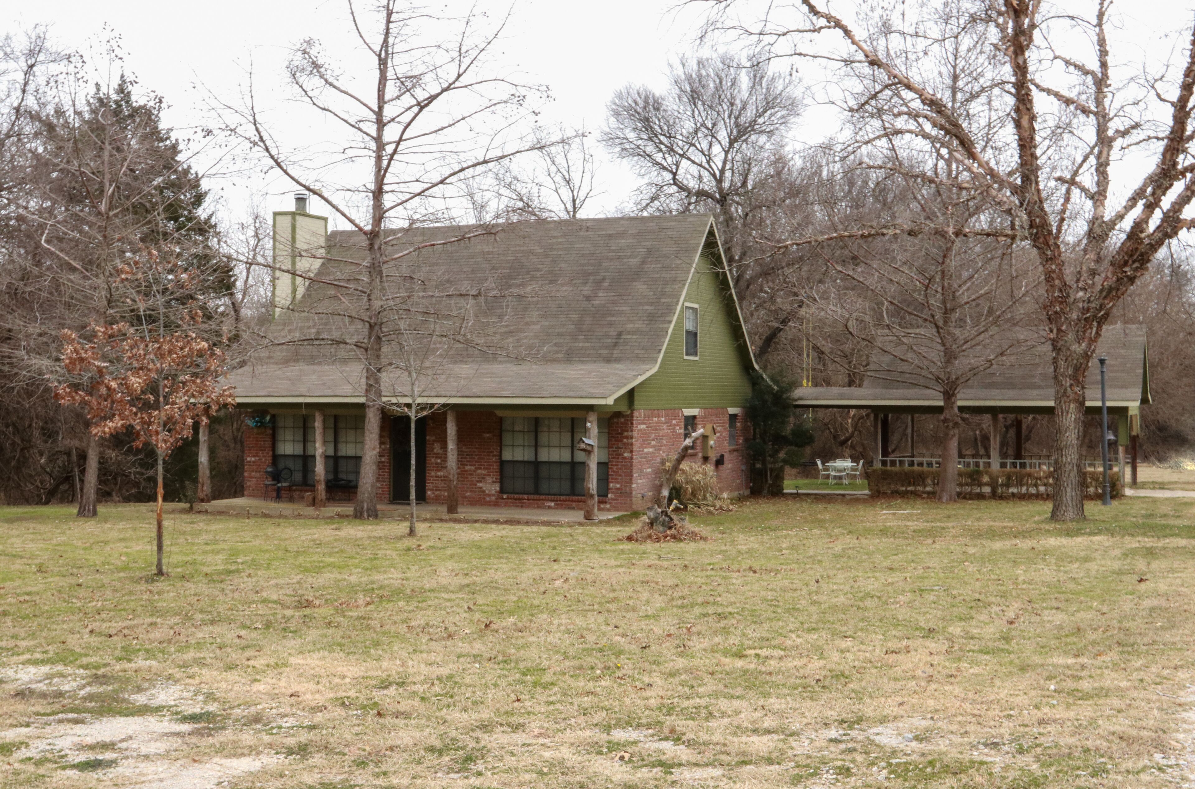 Cozy cottage nestled next to Hart's Creek, surrounded by trees and wildlife.