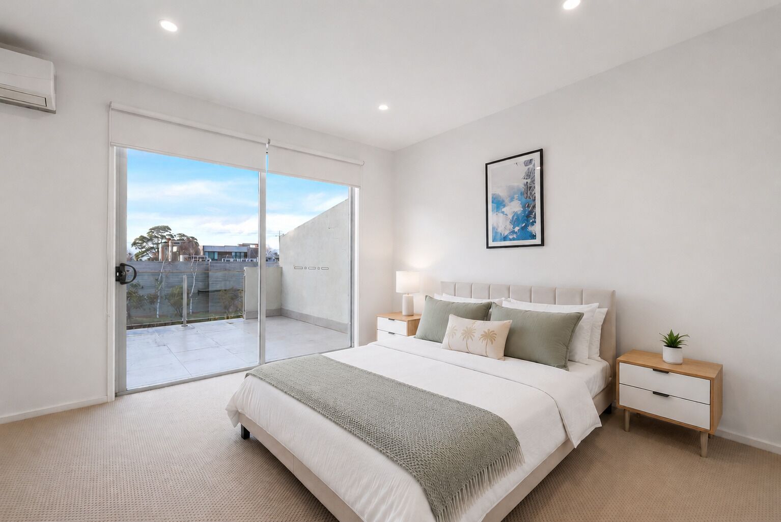 A bedroom with a bed, bedside tables, a nightstand, a window, and a door leading to a balcony.