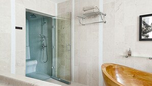 A modern bathroom with a glass-enclosed shower, a wooden bathtub, and a towel rack on the wall. - Bed & Breakfast in the town center (La Rochelle)