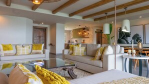 A spacious living area with a sofa set, a coffee table, and a hanging light fixture. - As Seen on CBS's Staycation•Resort & Beach Club Access•Concierge•Papagayo Luxury (Peninsula papagayo)