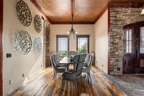 Gather around the elegant dining table, surrounded by rich hardwood floors, sophisticated finishes, and beautiful desert views. - Castle On Black Mountain, breathtaking panoramic views and outdoor entertainment! (Carefree)