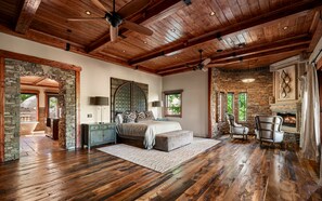 Retreat to the luxurious primary suite, featuring rich wood accents, a cozy fireplace, and a private covered patio with stunning desert views. This spacious sanctuary offers the perfect blend of elegance, comfort, and relaxation. - Castle On Black Mountain, breathtaking panoramic views and outdoor entertainment! (Carefree)