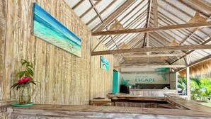 A rustic wooden interior with a bar area, wooden walls, and a ceiling with a woven pattern. - Gili Air Escape - Adults Only (Gili Air)