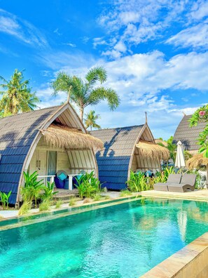 A resort with overwater bungalows, a swimming pool, and tropical vegetation. - Gili Meno Escape - Adults Only (Gili Meno)