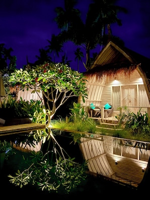 A thatched-roof bungalow with a pool, surrounded by tropical vegetation. - Gili Meno Escape - Adults Only (Gili Meno)