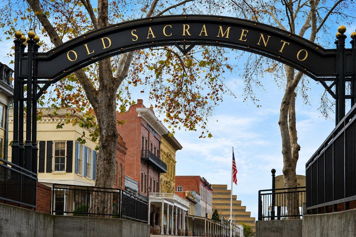 Una entrada histórica a la calle con un letrero que dice 'Old Sacramento'.