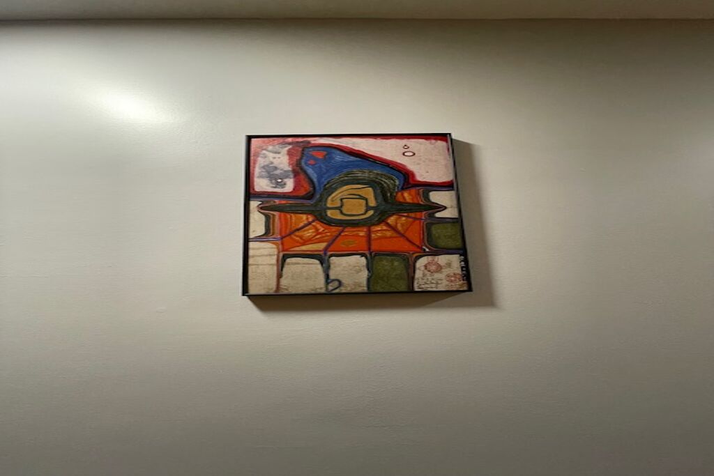 A painting on a plain wall.