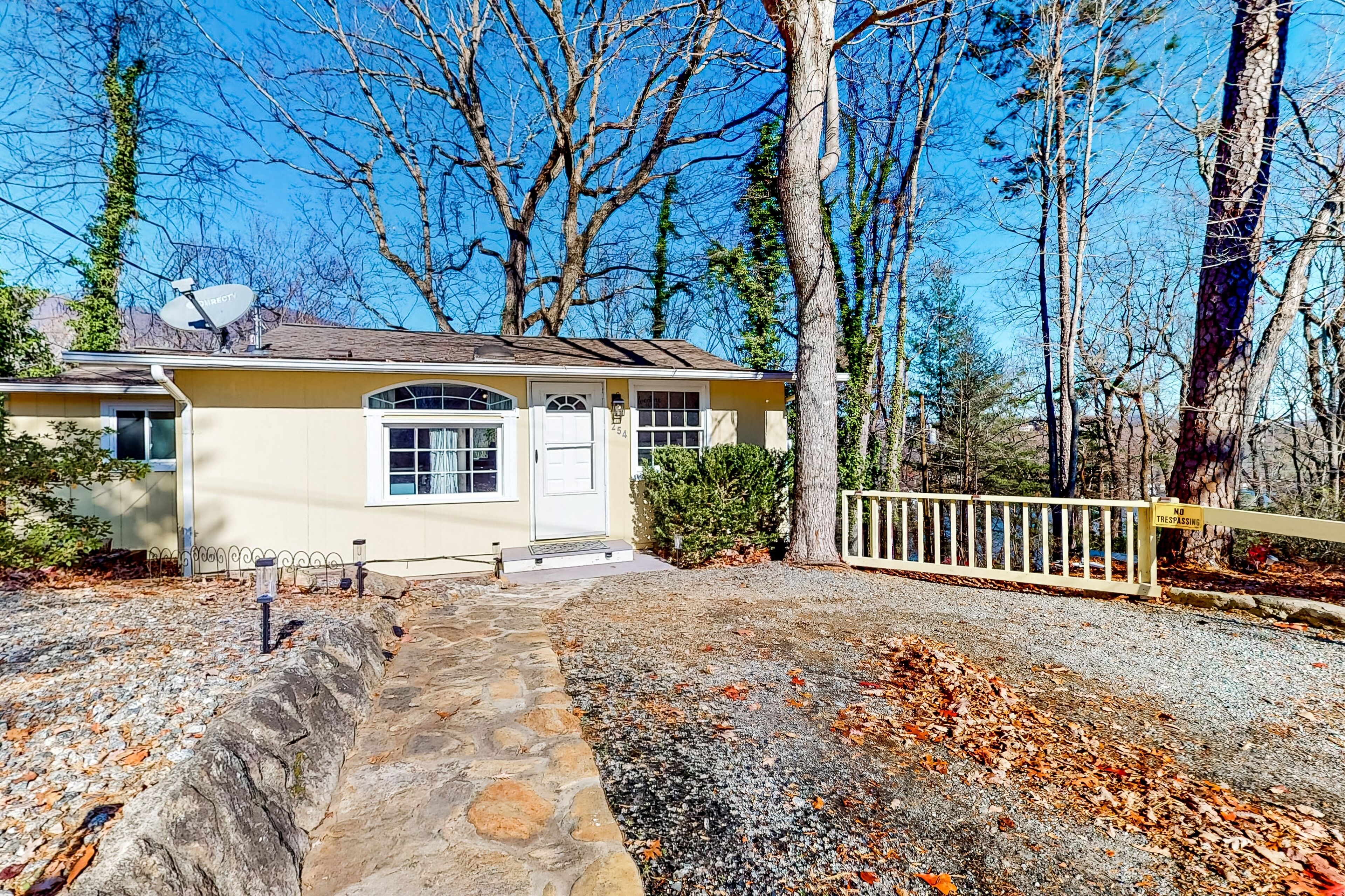 Tree-lined lake view abode with large deck, modern interior, board games, & W/D