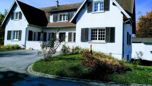 A two-story white house with black shutters, a sloped roof, and a visible chimney. - La Villa Champenoise (Pierry)