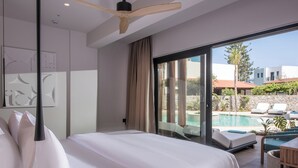A modern hotel room with a large bed, a ceiling fan, a view of a swimming pool, and a balcony with lounge chairs. - Noble Hotel Suites - Adults Only (Hersonissos)