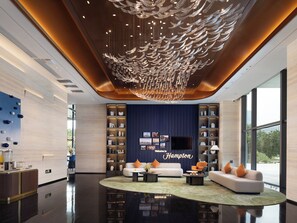 A modern lobby with a central seating area, a large chandelier, and a reception desk. - Hampton by Hilton Dongguan Liaobu Songshan Lake Avenue (Dongguan)