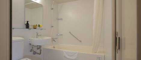 A modern bathroom with a toilet, sink, and bathtub.