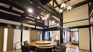 A traditional Japanese-style room with tatami flooring, a round wooden table, and low wooden chairs. - One Night One View One Destiny (Yotsukaido)
