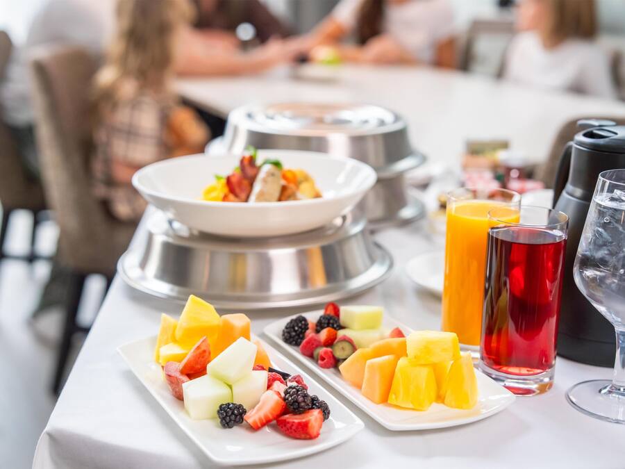 A breakfast buffet with various fruits and beverages.