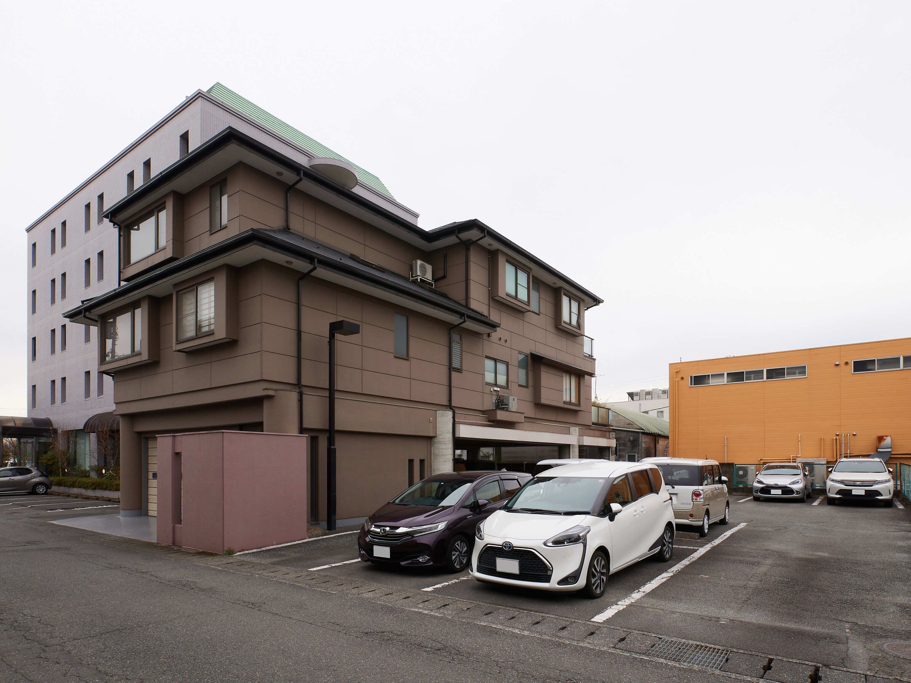 A multi-story parking garage with several cars parked.