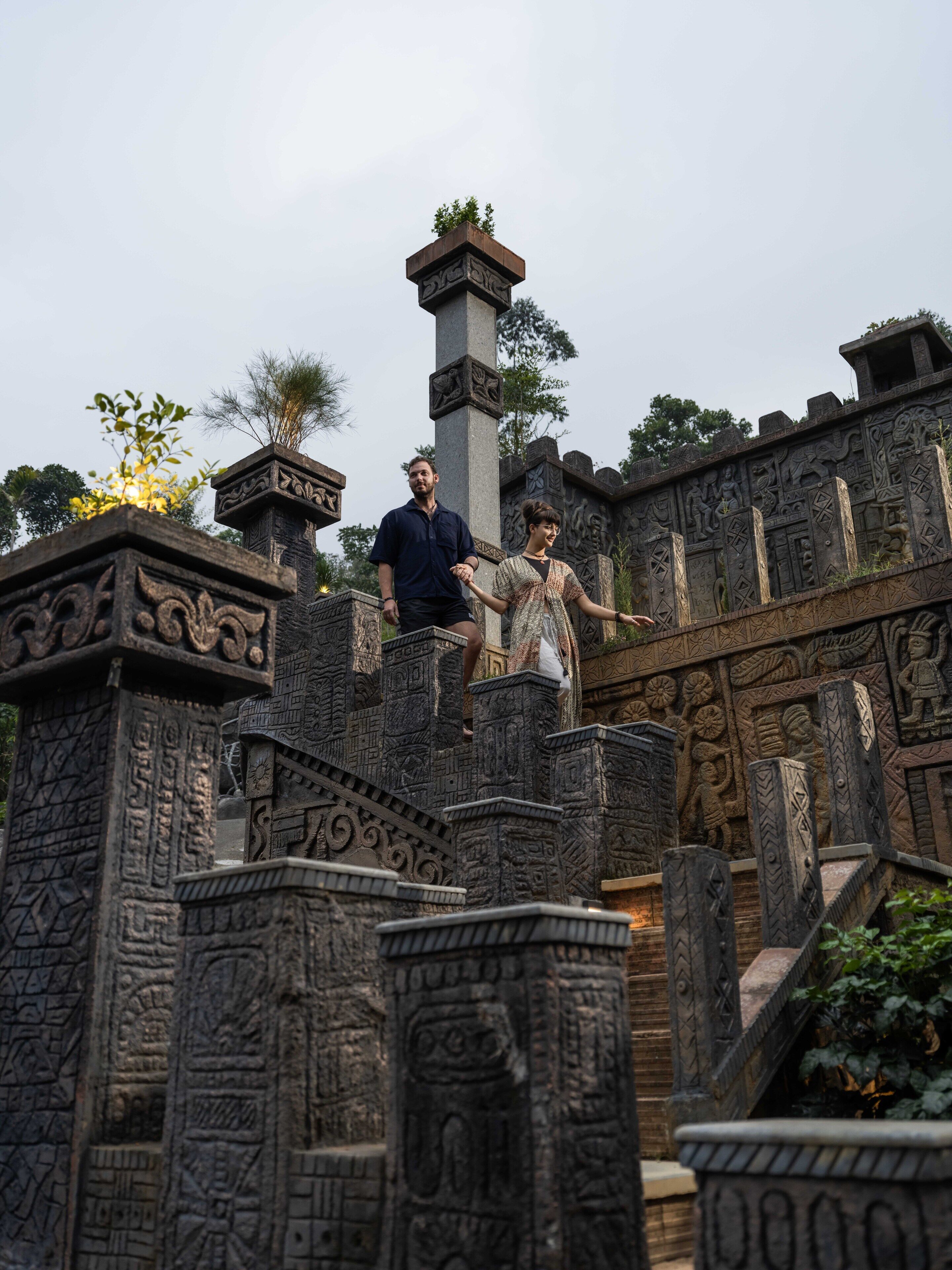 A stone structure with intricate carvings and a central pillar.