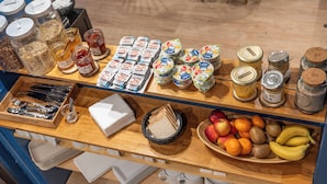 A breakfast buffet with various food items and condiments. - Hôtel du Théâtre (Bordeaux)