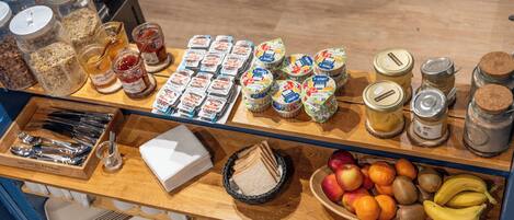 A breakfast buffet with various food items and condiments.