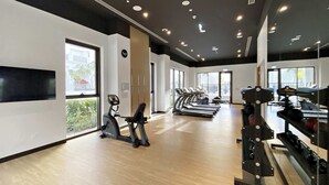 A gym with treadmills, stationary bikes, and weight machines. - Silkhaus Surf 1 Dubai Creek Harbour (Dubai)