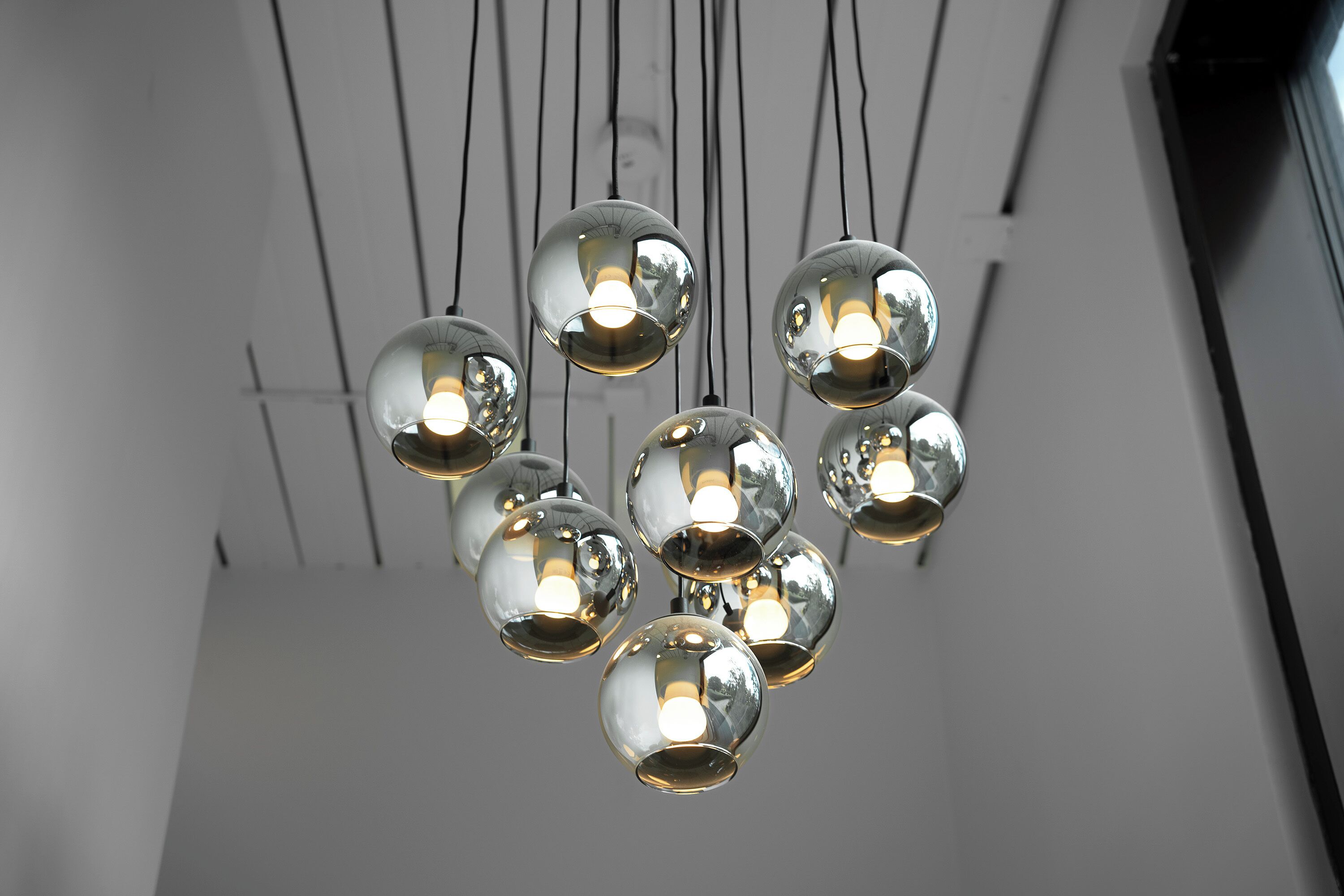 A chandelier with multiple spherical glass bulbs.