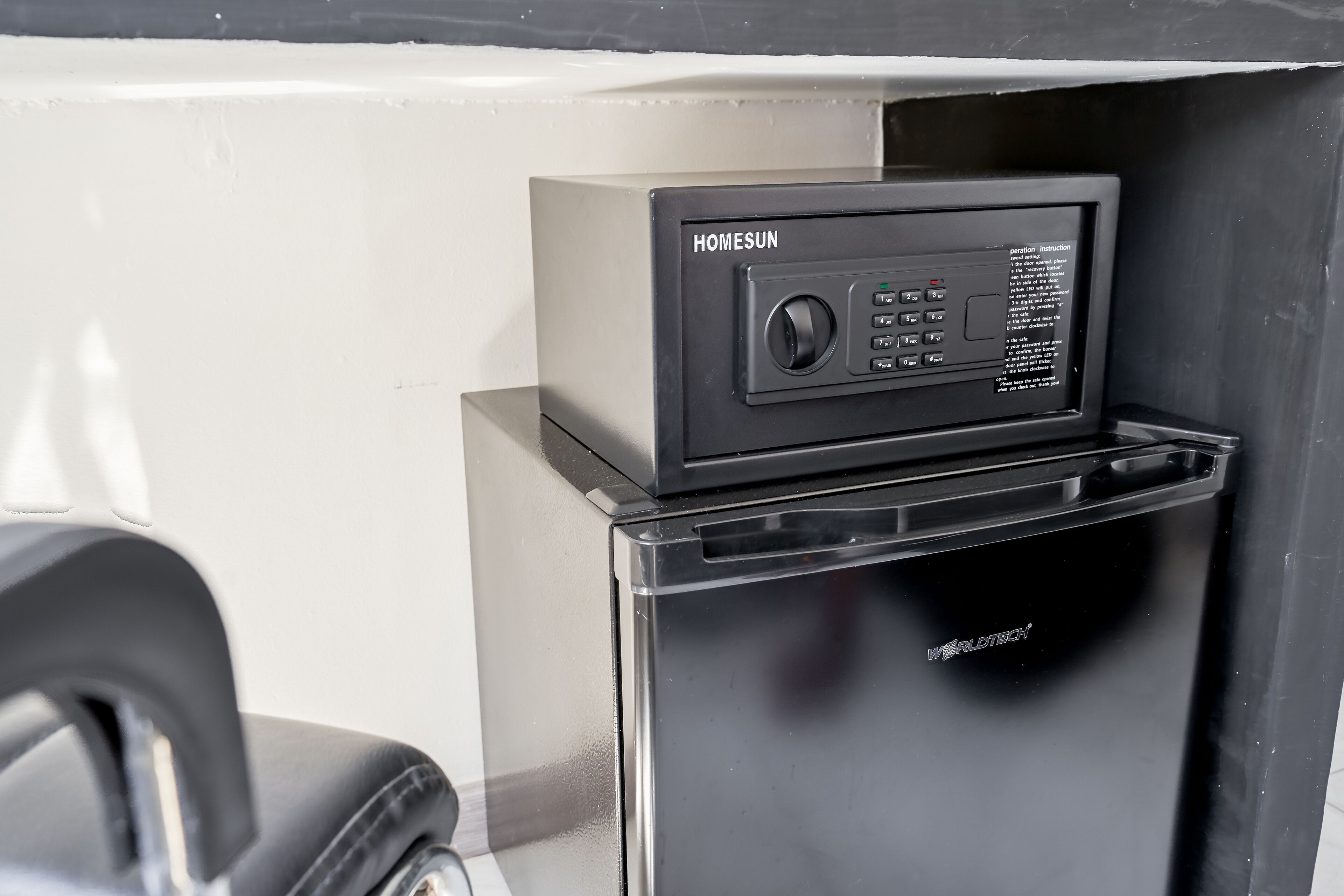 A black refrigerator with a control panel labeled "HOMESUN" and "WORLDTECH" on the bottom.