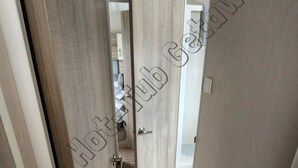 A hallway with wooden flooring and a door leading to a room. - 6 Berth luxury holiday home at Tattershall Lakes. Private Hot-Tub. Pet Friendly (Lincoln)