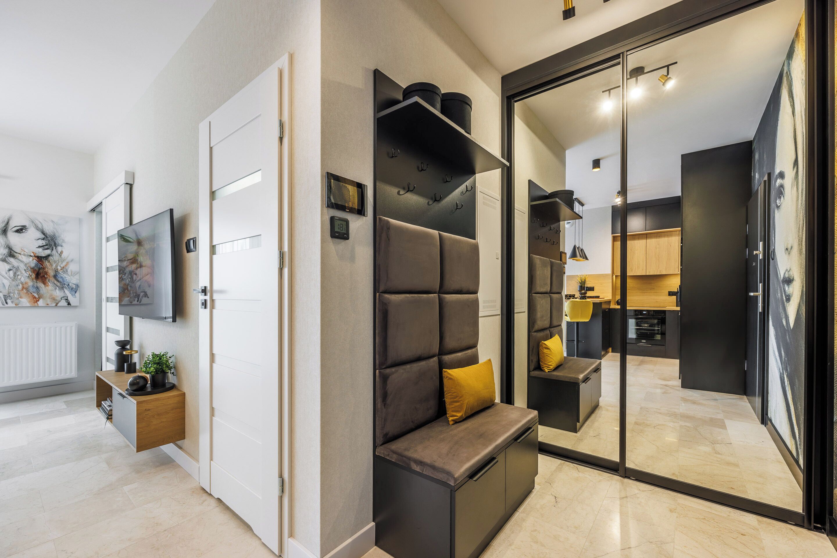 A modern interior with a seating area, a kitchen, and a living space.