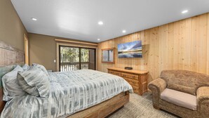 A bedroom with a wooden bed, a wooden dresser, a sofa, and a large window with blinds. - Ridge Court # 14 at Palisades - Ski Shuttle, Dog OK (Olympic Valley)
