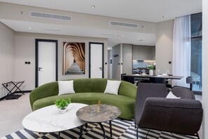 Exclusive Apartment | Living area | 65-inch Smart TV with cable channels, Netflix, streaming services - Waves - Seaside Splendor 2BR in Dubai's Business Bay (Dubai)