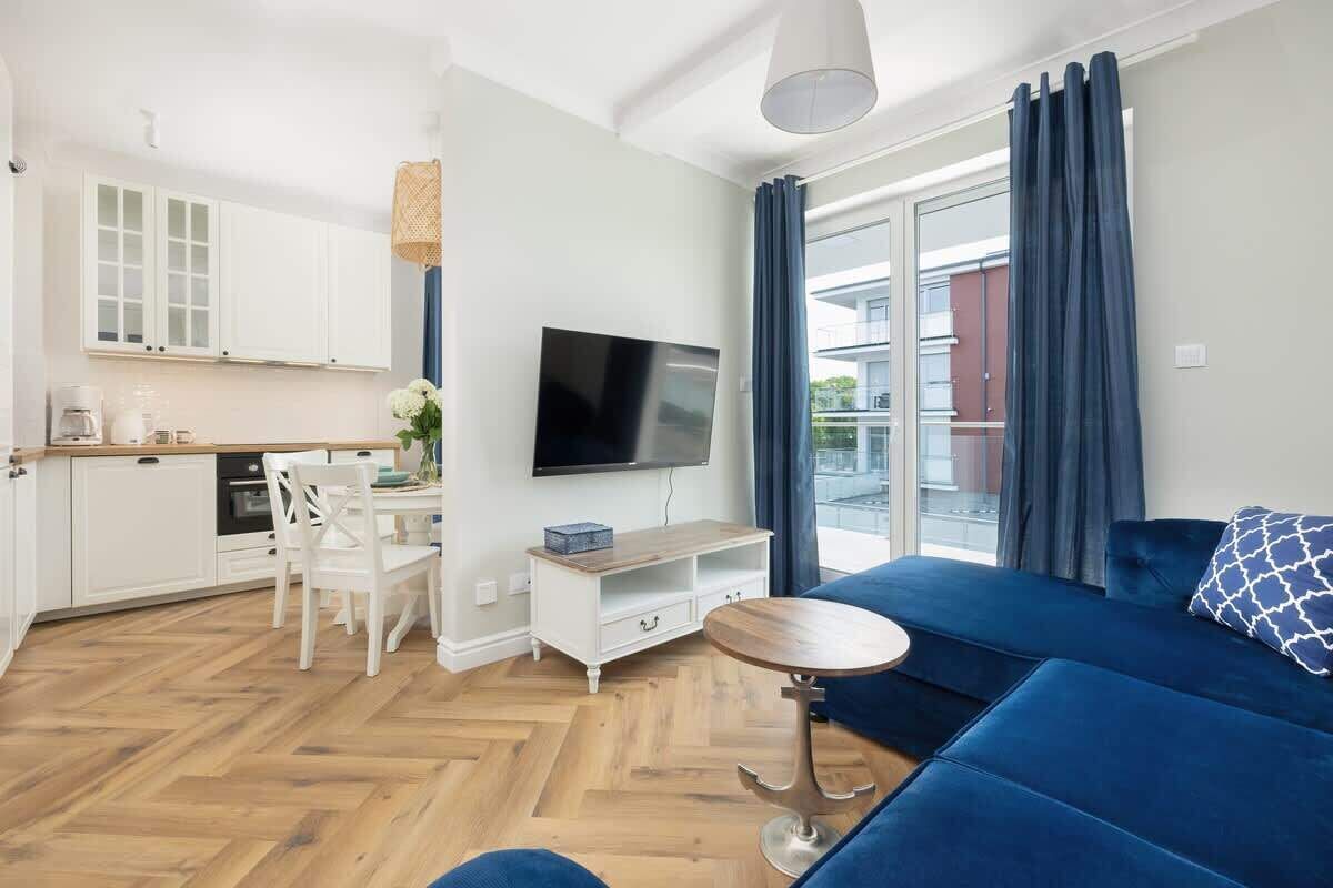 A modern apartment with a kitchen, dining area, and living room.