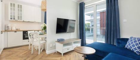 A modern apartment with a kitchen, dining area, and living room.