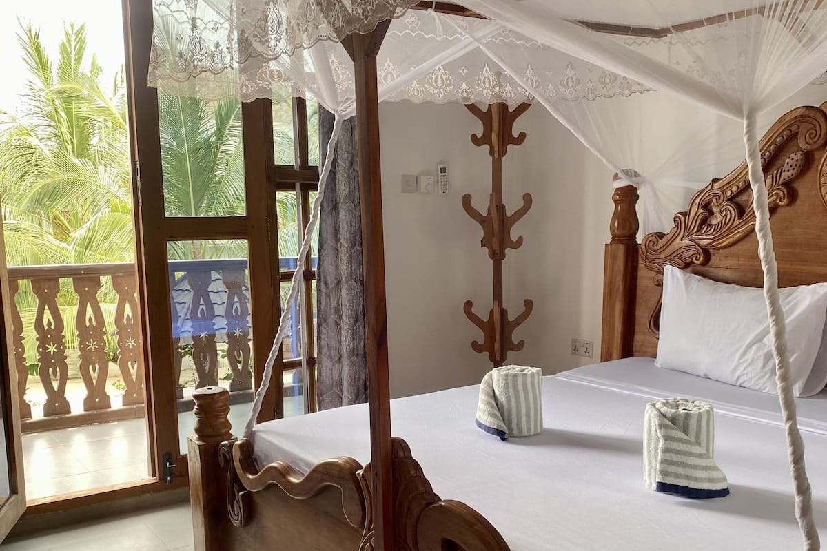 Deluxe Room, 1 King Bed, Pool View | 1 bedroom, desk, laptop workspace, free WiFi