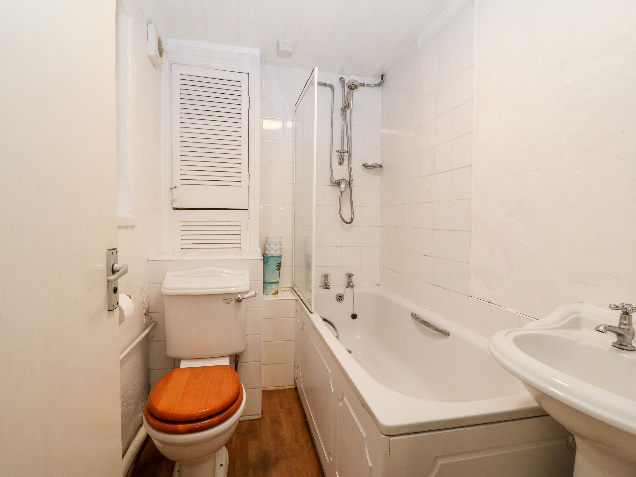Un baño pequeño con inodoro, lavabo y bañera.