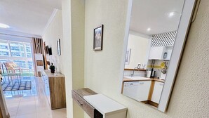 A modern bathroom with a large mirror, a white countertop, and a wooden cabinet. - T1029 - Comfort and Style in Cala de Villajoyosa (Villajoyosa)