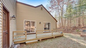 A two-story house with a wooden deck and a front porch. - Tranquil Ogunquit Condo: Walk to Beach & Marina! (Ogunquit)