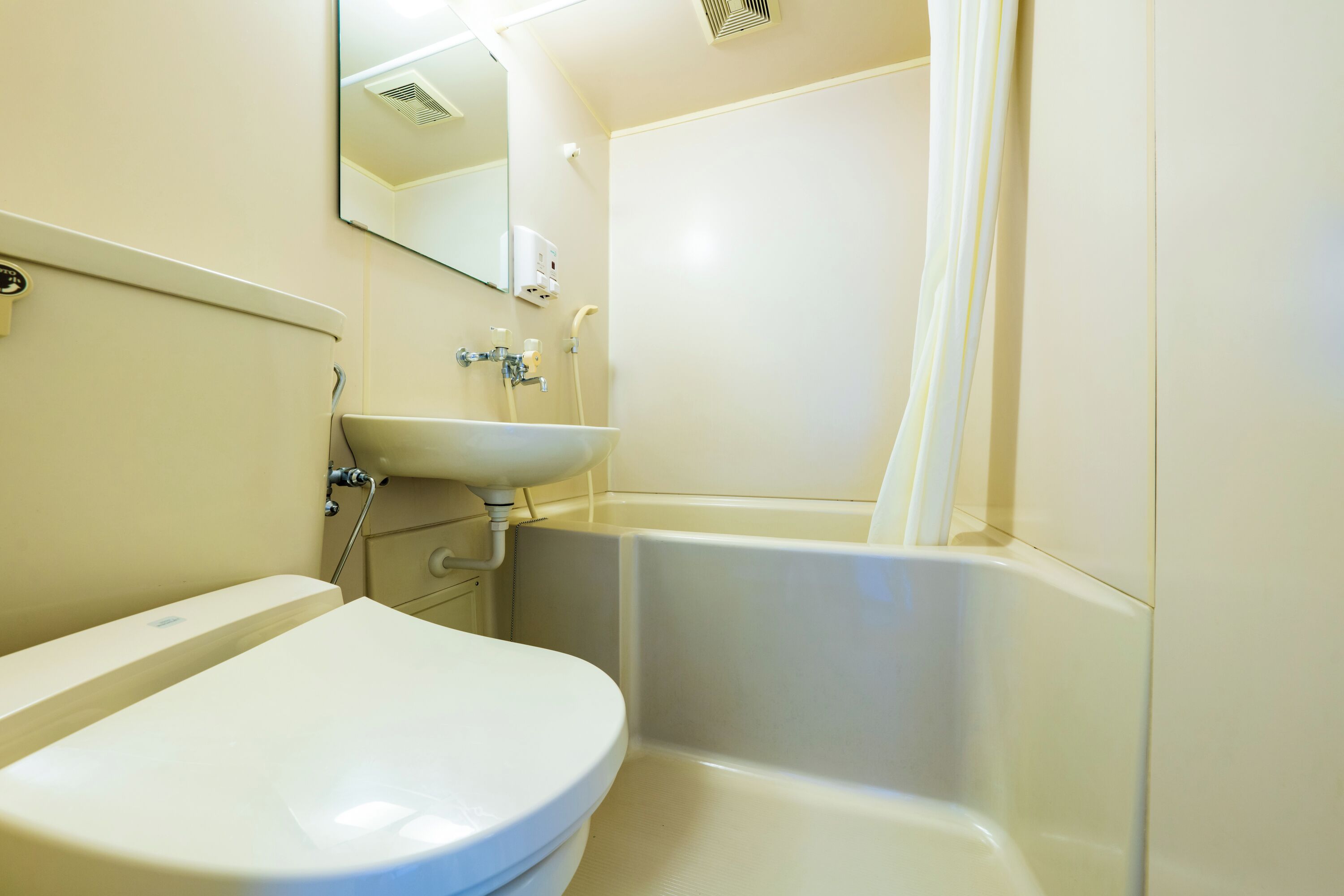 A bathroom with a toilet, sink, and bathtub.