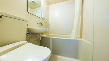 A bathroom with a toilet, sink, and bathtub.