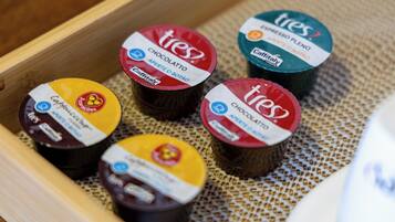 A tray with five containers of Tres coffee, each labeled with different flavors.