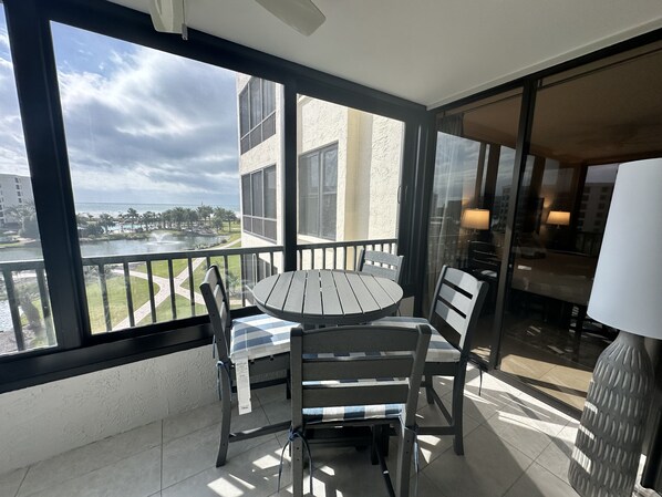 Outdoor dining - Modern Condo! Beach Access, Shared Pools, and Activities! Gulf and Bay Club D409 (Siesta Key)